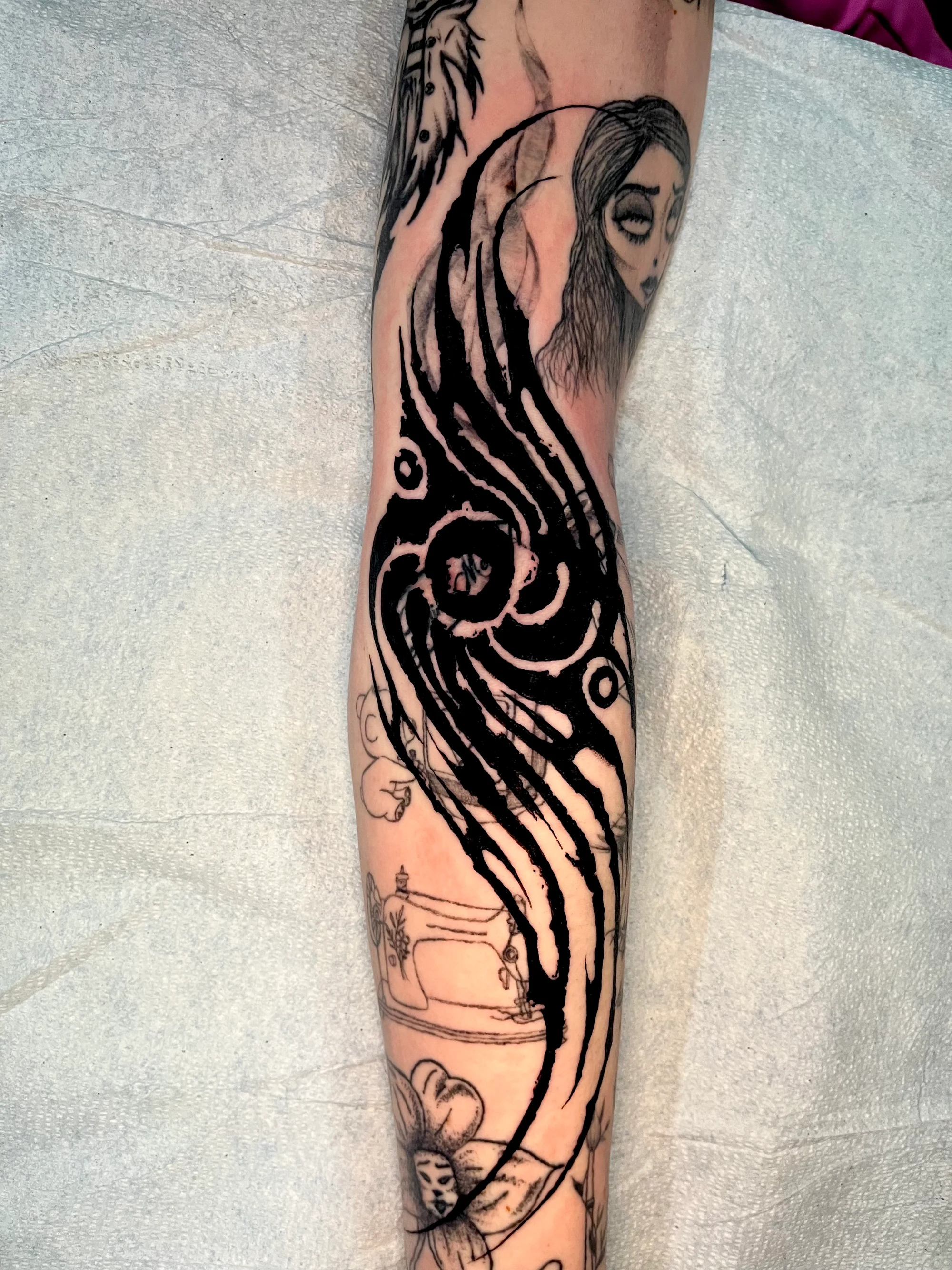 Ghostly figure with flowing black hair on forearm