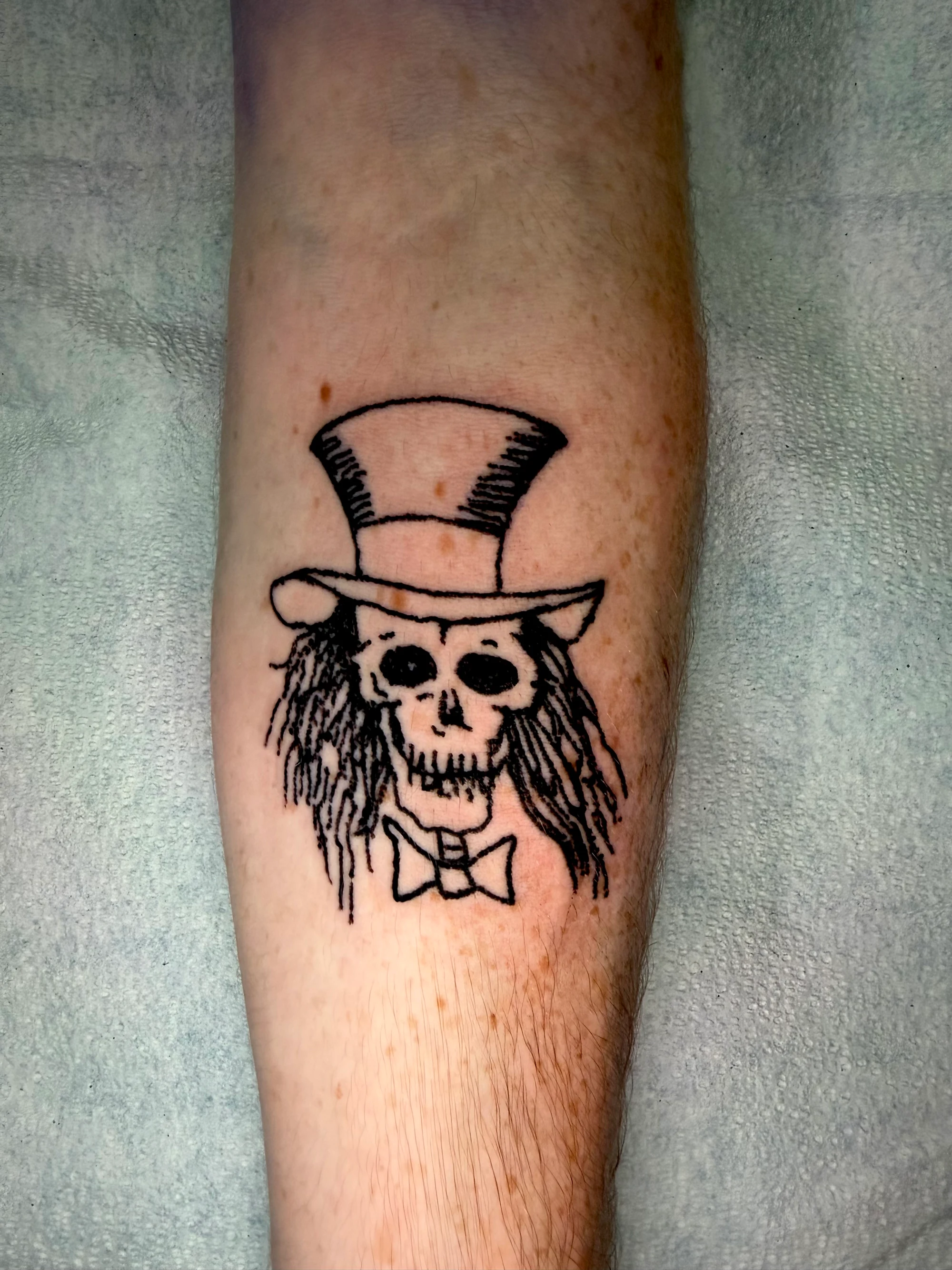 Top-hat skull with bowtie tattoo